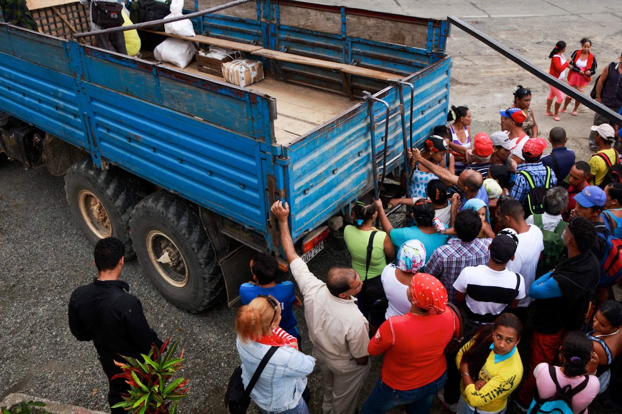 The Art of Drawing Readers In: Your attractive post title goes here A crowd surrounds a large blue truck outdoors, capturing a lively and engaging scene.