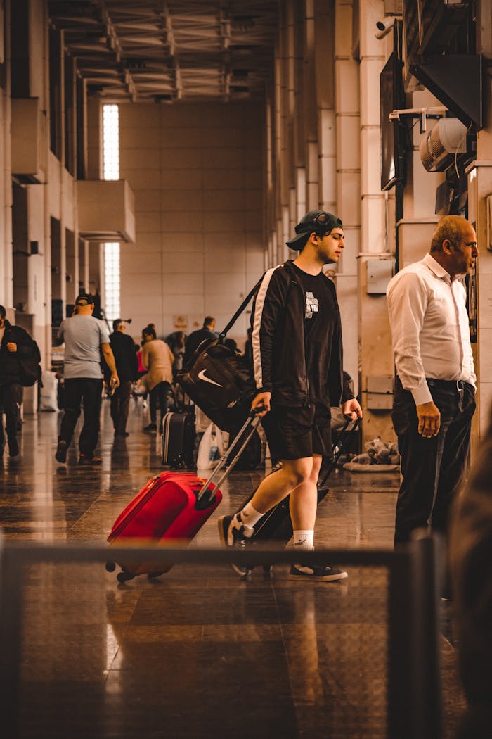 Crafting Captivating Headlines: Your awesome post title goes here A young traveler with a red suitcase navigating a busy terminal.