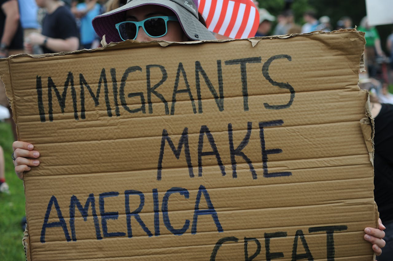 Mastering the First Impression: Your intriguing post title goes here Close-up of sign reading 'Immigrants Make America Great' at a Baltimore rally.